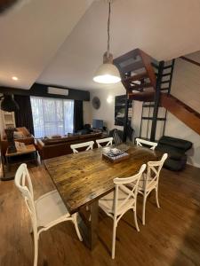 a living room with a wooden table and chairs at Margarets Forest in Margaret River Town