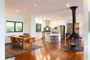 a kitchen and dining room with a wood stove at Balmoral 575 in Montville