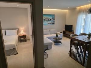 a hotel room with a bed and a living room at Velithea Luxury Suites in Ioannina