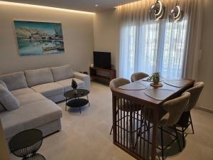 a living room with a couch and a table at Velithea Luxury Suites in Ioannina