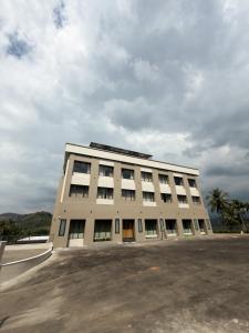 a large white building with a lot of windows at Dwaraka INN in Arīkkod