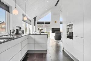 a kitchen with white cabinets and a large window at G331-Lemvig-Myntevej-31 in Lemvig