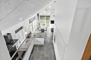a large white kitchen with a sink and a table at G331-Lemvig-Myntevej-31 in Lemvig