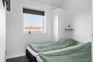 a white room with a bed and a window at G331-Lemvig-Myntevej-31 in Lemvig