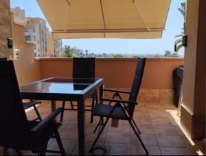 a ping pong table and two chairs on a balcony at Beachfront on Isla Canela in Punta del Caimán