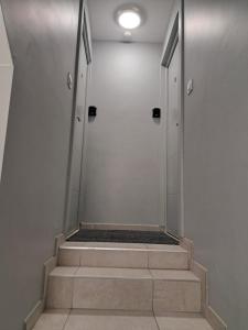 a staircase in a building with two doors and a stairwell at La parenthèse Lémantine - Studio 2 in Neuvecelle