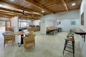 a room with tables and chairs and a dining room at Zambezi Drift Inn in Livingstone