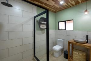 a bathroom with a toilet and a sink at Zambezi Drift Inn in Livingstone