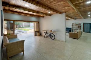 a living room with a bike and a table at Zambezi Drift Inn in Livingstone