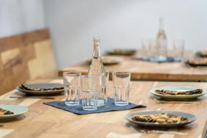 a wooden table with glasses and a bottle on a napkin at Zambezi Drift Inn in Livingstone +19 photos