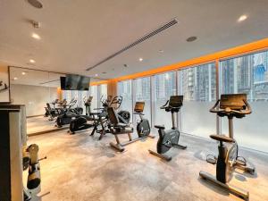 a gym with a bunch of exercise equipment in a building at Vogue Vacation Homes, Downtown Opera Grand near Burj Khalifa and Dubai Mall, Two Bedroom Apartment with Large Balcony and Burj Khalifa view, Access to all Amenities in Dubai