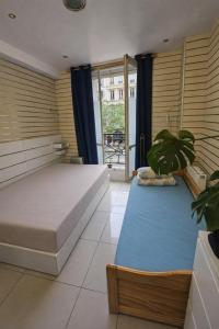 a bedroom with two beds and a potted plant at Korean Style Minbak Number Two PARIS in Paris +30 photos