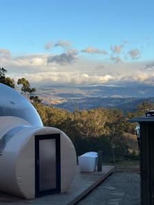 a white tent sitting on a table with a view at Romantic Stargazing Retreat - Beyond Bubbles in Kanimbla +6 photos