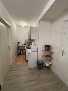 a small kitchen with a white refrigerator in a room at Einzel Zimmer Metz in Metz