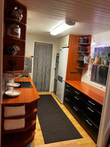 a kitchen with wooden cabinets and a white refrigerator at Aurora Gateway N4 in Inari