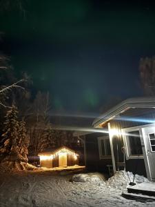 an image of the aurora dancing in the sky above a house at Aurora Gateway N4 in Inari