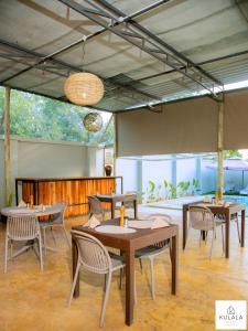 a restaurant with tables and chairs in a room at Kulala Stays Lodge in Livingstone