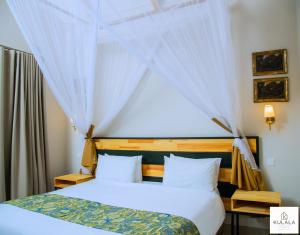 a bedroom with two beds and a window at Kulala Stays Lodge in Livingstone +23 photos