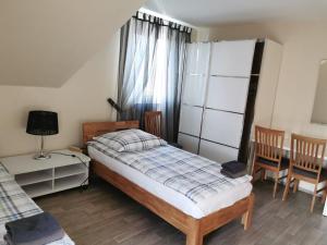 a bedroom with a bed and a table and chairs at Gästehaus Sol Tour in Ahrensfelde