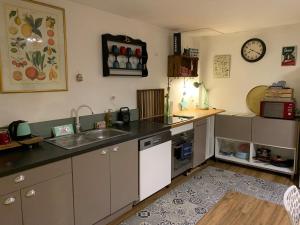 a kitchen with a sink and a counter top at Maison cocooning in Hazebrouck