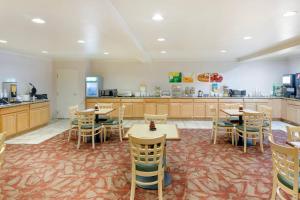 a restaurant with tables and chairs and a kitchen at Quality Inn Payson I-15 in Payson