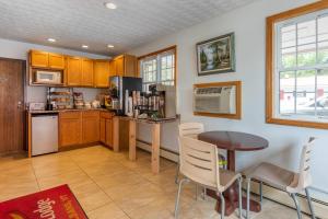 a kitchen with a table and a table and chairs at Econo Lodge Saint Albans in Saint Albans