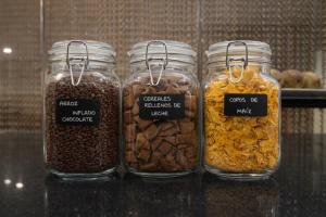 four glass jars filled with different types of nuts at Hotel Amaltea by Executive Sport in Lorca +13 photos