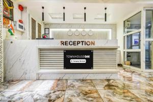 a store front with a sign that reads reception at Townhouse Oak PTC Indore Junction in Indore
