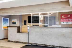 a lobby with a large marble counter top in a building at Econo Lodge Whitehall near Michigan's Adventure in Whitehall