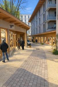 a group of people walking down a street next to a building at C'est La Vie Korean Style Minbak PARIS in Bagnolet