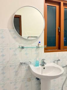 a bathroom with a sink and a mirror at The Kasbo in Unawatuna +5 photos