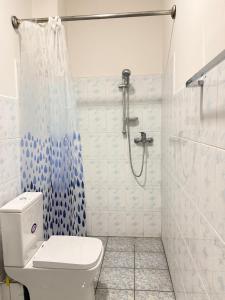 a bathroom with a shower and a toilet in it at The Kasbo in Unawatuna