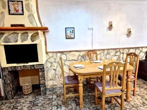 a dining room with a table and a stone fireplace at Casa Caloret - Playa y centro a 2 min in Vinarós