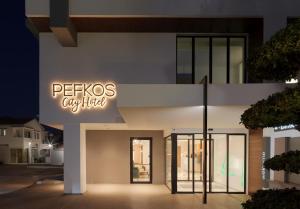 a building with a sign that reads petsos cyberfield at Pefkos City Hotel in Limassol