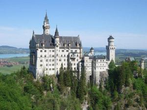 a large castle on top of a mountain at Allgaeuer-Landhaus-Stocker in Hopferau