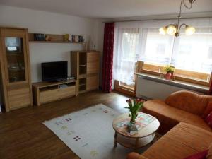 a living room with a couch and a table at Allgaeuer-Landhaus-Stocker in Hopferau