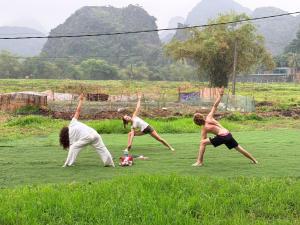 a group of young boys playing in a field at Forest Sunset hostel in Ninh Binh