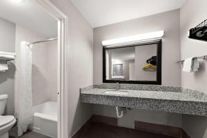 a bathroom with a sink and a mirror at Econo Lodge Inn & Suites Laredo - Nuevo Laredo in Laredo +45 photos