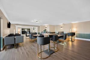 a dining room with chairs and tables in a building at Quality Inn Fort Myers Cape Coral in Fort Myers