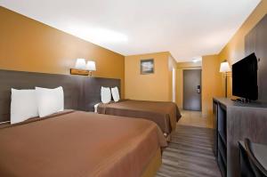 a hotel room with two beds and a flat screen tv at Econo Lodge Allentown North in Allentown