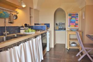 a kitchen with a sink and a counter top at Dammuso La Ginestra in Pantelleria +5 photos