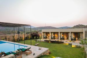 an image of a villa with a swimming pool at SaffronStays Villa Rohi in Udaipur