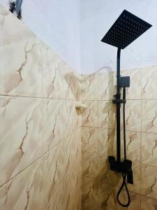 a shower with a light on top of a wall at Velora Villa Tangalle in Tangalle