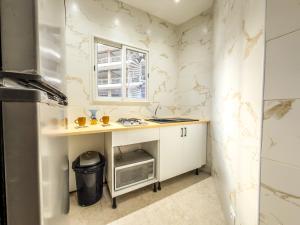 a small kitchen with a sink and a window at Lafayette Central Apartment-Tunis in Tunis