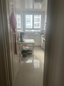 a kitchen with a sink and a table in it at Bagneux cozy in Châtillon