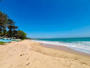 a sandy beach with the ocean in the background at Velora Villa Tangalle in Tangalle