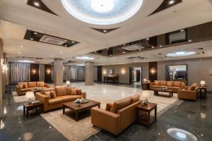 a lobby with couches and tables in a building at Mangalam Resort & Spa - Member of Absolute Collection in Aurangabad