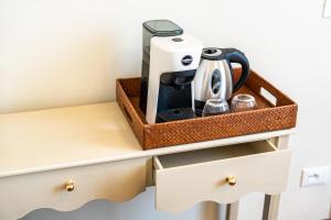 a tray on a desk with a coffee maker on it at Lumi Stays in Florence +32 photos