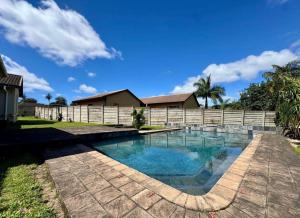 a swimming pool in a backyard with a fence at One Birdswood in Richards Bay