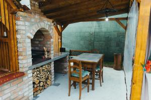 a patio with a table and a brick oven at Apartman Marta i soba Maja in Gradište +39 photos